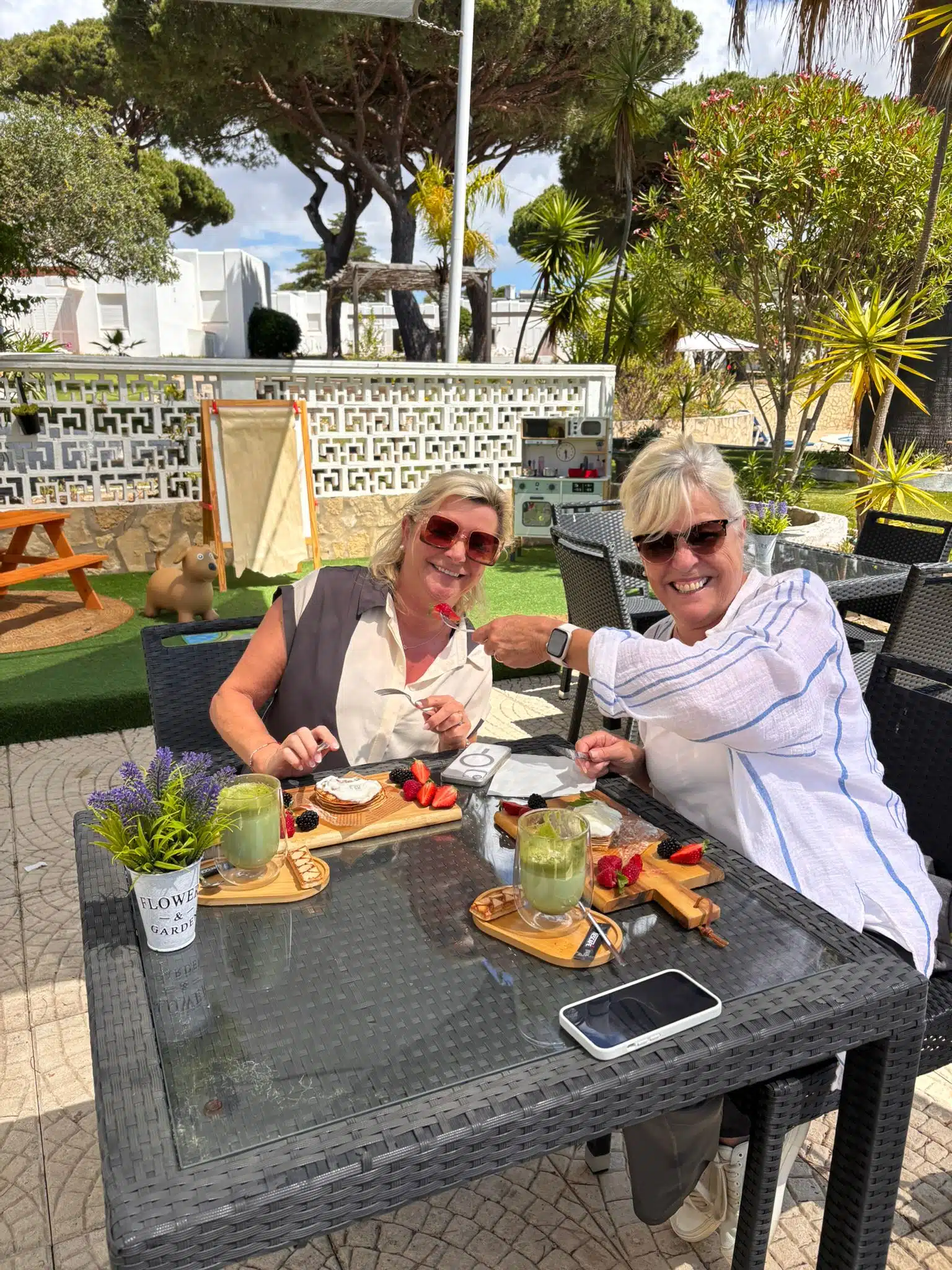 Guests enjoying drinks at an outdoor table