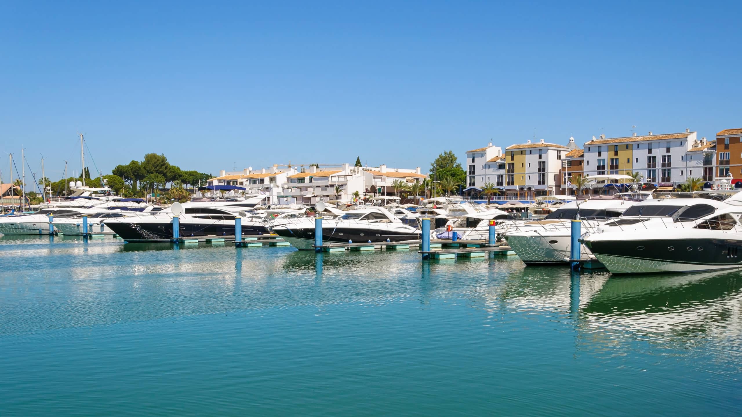 Luxury yachts moored in Vilamoura marina, a short walk from Luz Aura Café